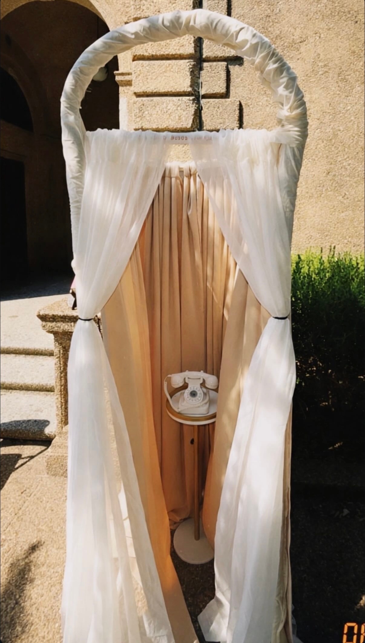 Draped archway installation with vintage telephone